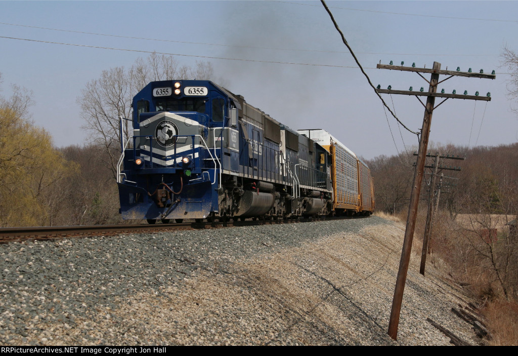 With the tail end still crossing the diamond, a pair of LSRC SD50's work hard to keep the train moving